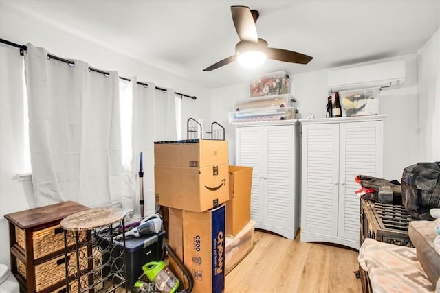 interior space with ceiling fan and an AC wall unit