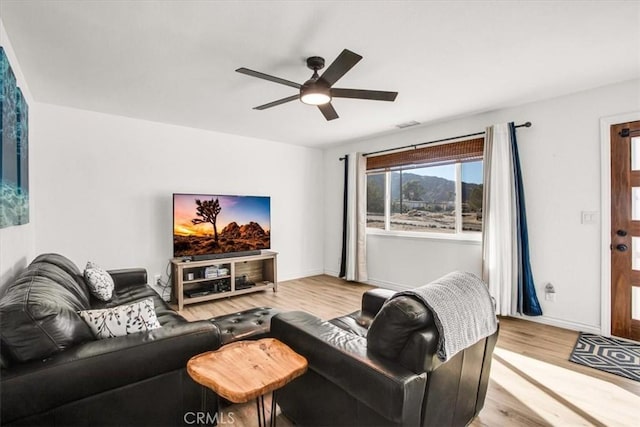 living room featuring ceiling fan and light wood-type flooring