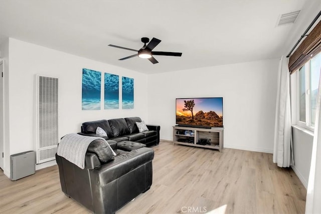 living room with light wood-type flooring and ceiling fan