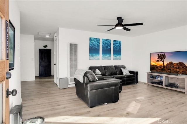 living room with ceiling fan and light hardwood / wood-style flooring