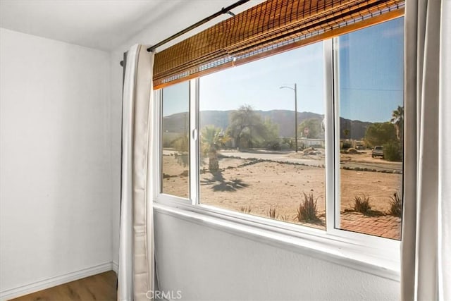 doorway to outside with a mountain view and hardwood / wood-style floors