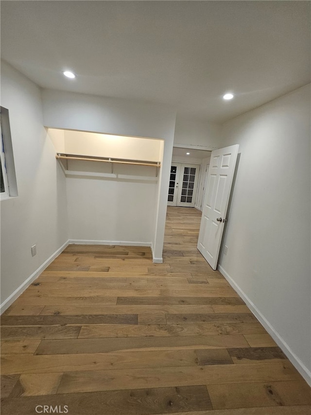 walk in closet with hardwood / wood-style flooring