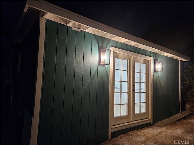 doorway featuring french doors and wooden walls