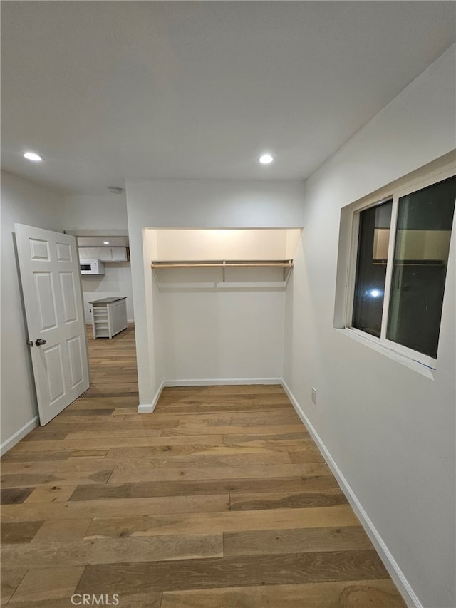 walk in closet with wood-type flooring