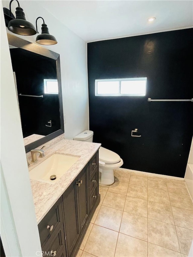 full bath with vanity, toilet, and tile patterned floors