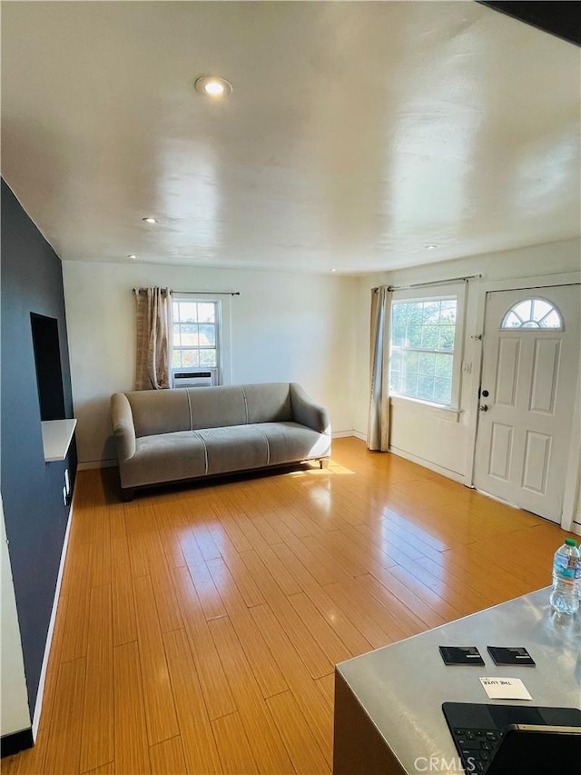 living area featuring baseboards, recessed lighting, plenty of natural light, and light wood-style floors