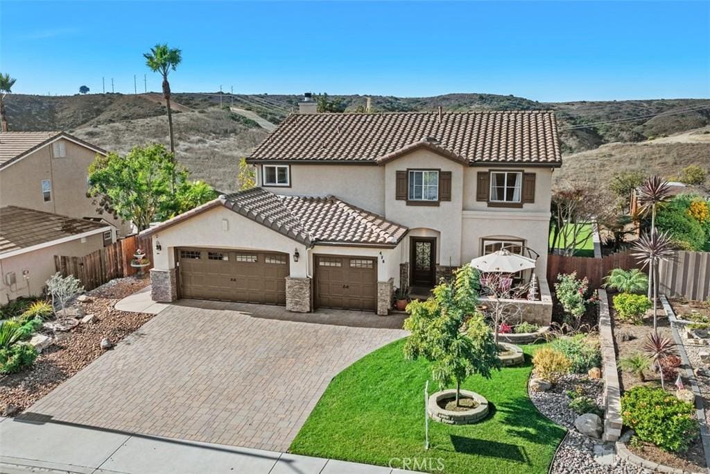 mediterranean / spanish-style home featuring a mountain view and a front yard