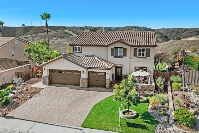 mediterranean / spanish-style home featuring a mountain view and a front yard