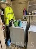 clothes washing area featuring separate washer and dryer