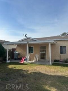 rear view of house with a lawn