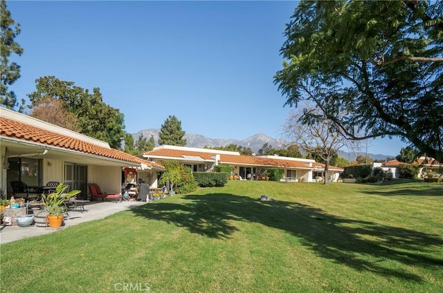 view of yard with a mountain view and a patio