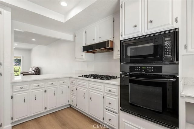 kitchen featuring light wood-type flooring, white cabinetry, and stainless steel gas cooktop