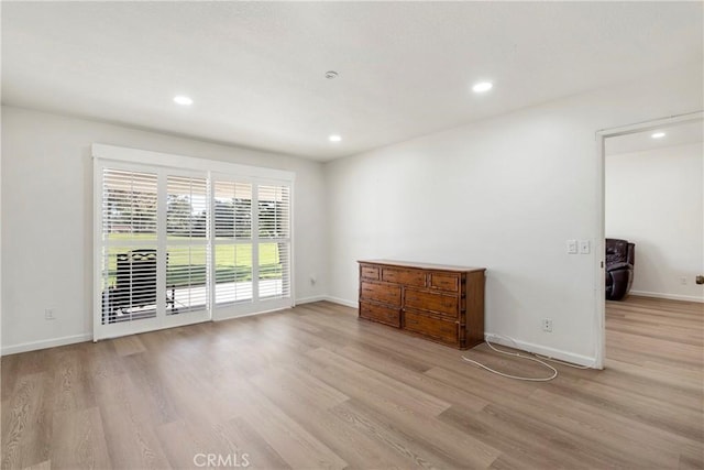 unfurnished room with light wood-type flooring