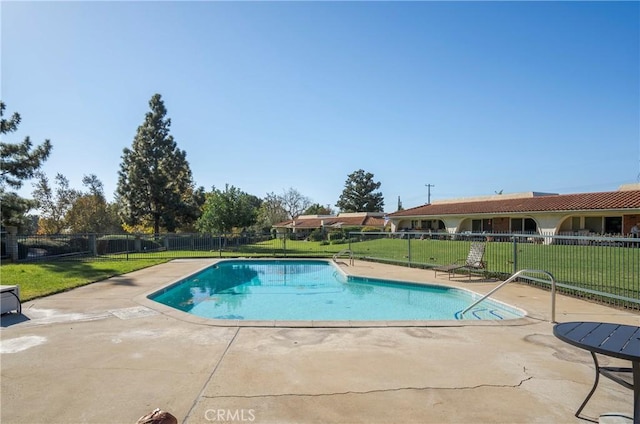 view of pool featuring a yard and a patio