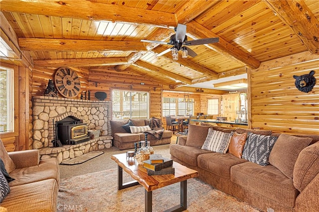 carpeted living room with lofted ceiling with beams, a wood stove, ceiling fan, and wood ceiling