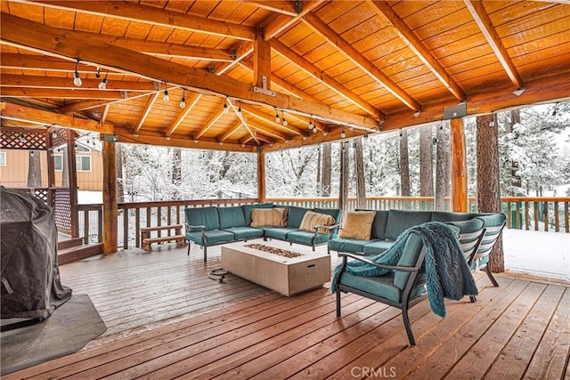 snow covered deck with a gazebo, area for grilling, and an outdoor living space with a fire pit