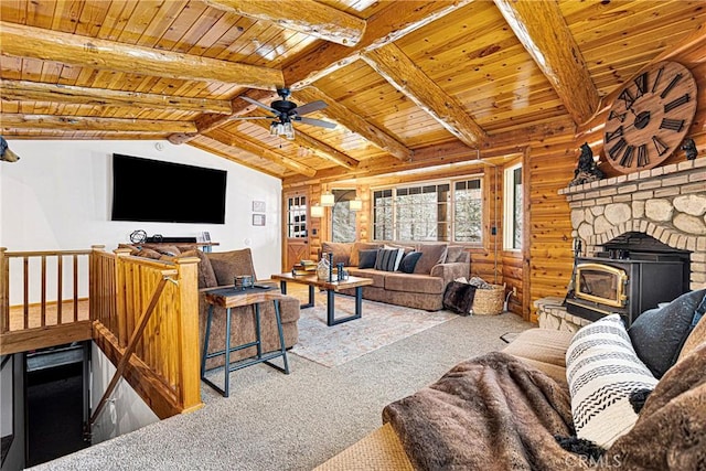 living room featuring wood ceiling, light colored carpet, ceiling fan, lofted ceiling with beams, and a wood stove