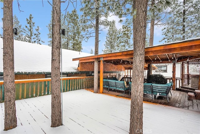 snow covered deck featuring an outdoor living space