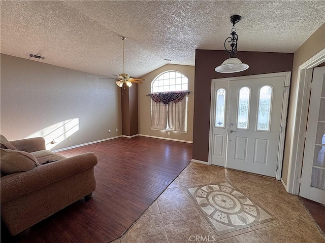 entryway featuring hardwood / wood-style floors, a textured ceiling, ceiling fan, and lofted ceiling