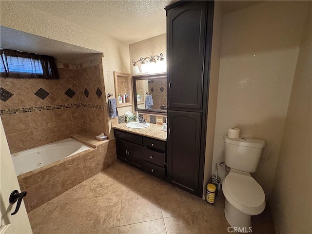 bathroom featuring a textured ceiling, vanity, a relaxing tiled tub, and plenty of natural light