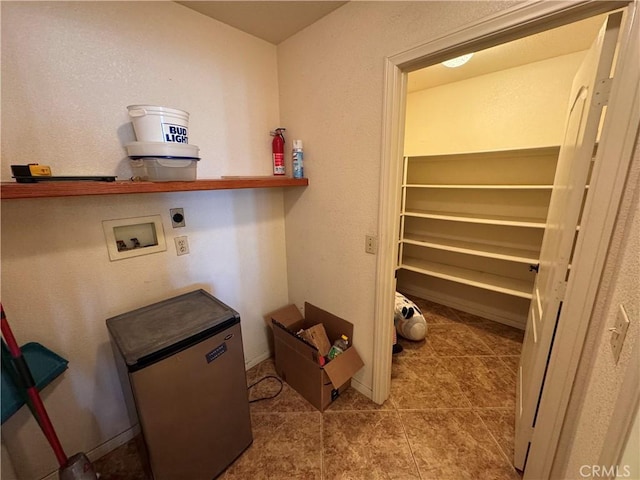 laundry area featuring electric dryer hookup, tile patterned floors, and washer hookup