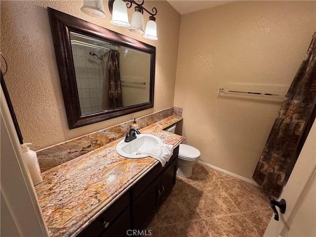 bathroom with tile patterned floors, a shower with curtain, vanity, and toilet