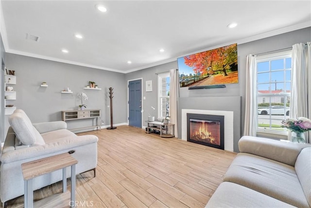 living room with light hardwood / wood-style floors and ornamental molding