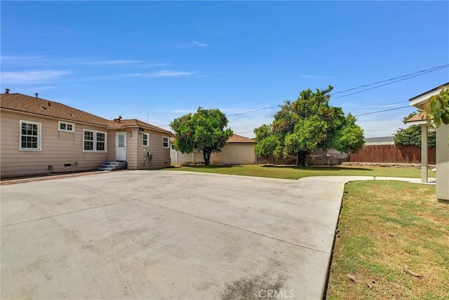 back of property with a patio area and a yard