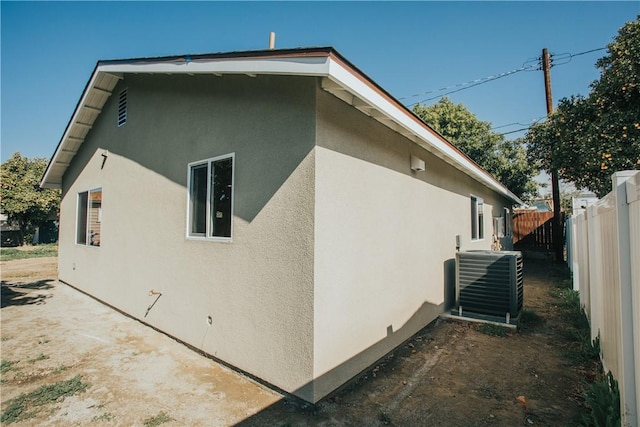 view of side of property featuring central air condition unit