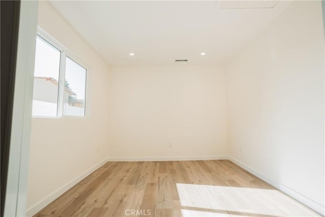 spare room featuring light hardwood / wood-style flooring