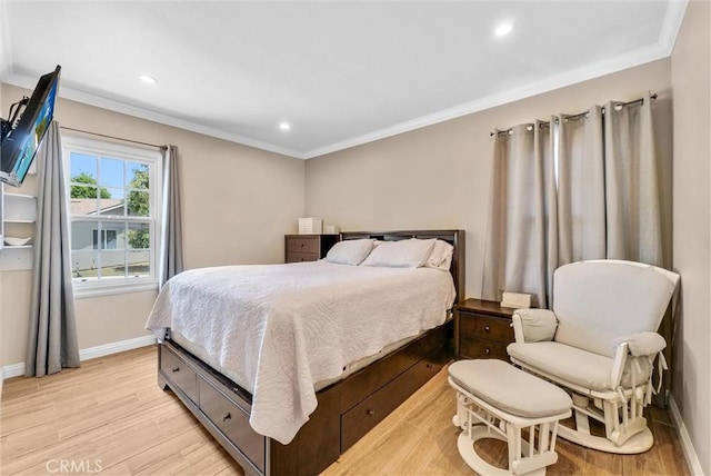 bedroom with light hardwood / wood-style floors and crown molding