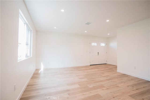 empty room with light hardwood / wood-style floors