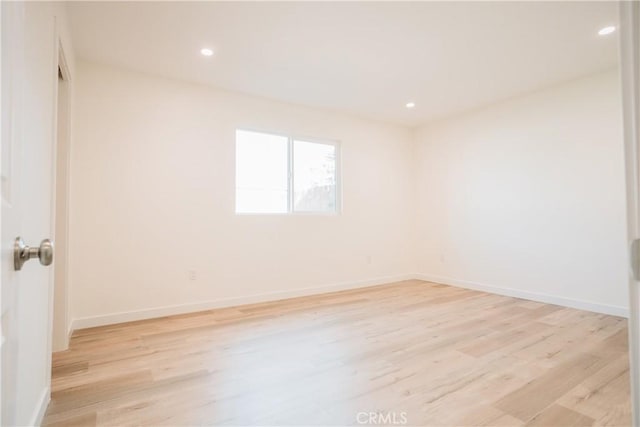 spare room featuring light hardwood / wood-style flooring