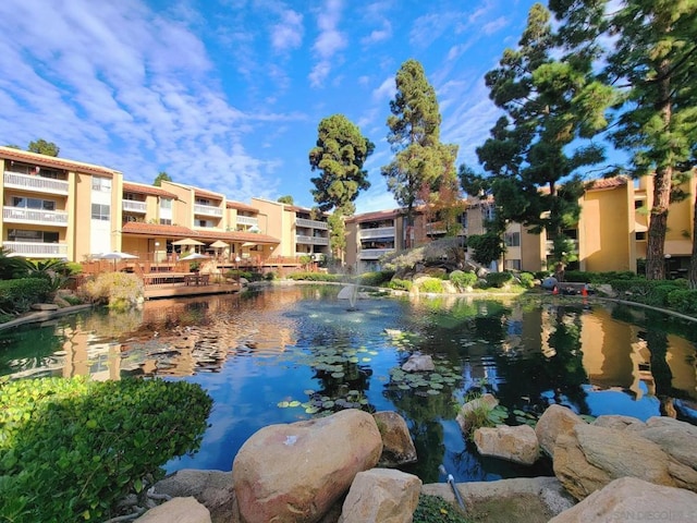 view of water feature with a garden pond