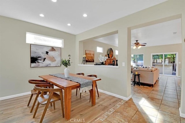 dining room with ceiling fan and light wood-type flooring