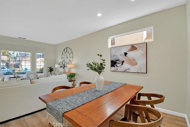 dining area featuring light wood-type flooring