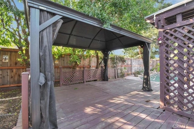 wooden terrace featuring a gazebo