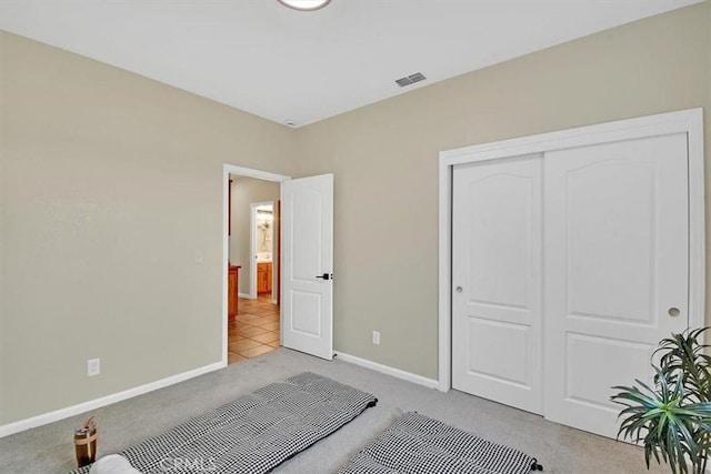 carpeted bedroom with a closet