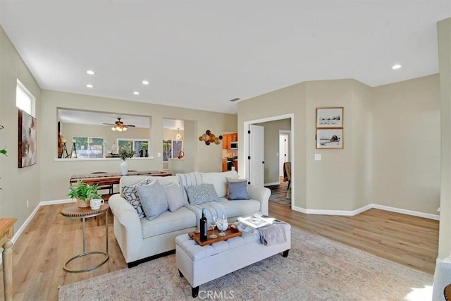 living room with ceiling fan and light hardwood / wood-style floors