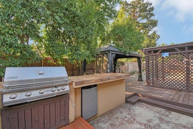 view of patio / terrace featuring a gazebo, a grill, and a wooden deck