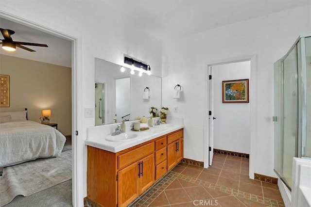 bathroom with tile patterned floors, ceiling fan, a shower with door, and vanity