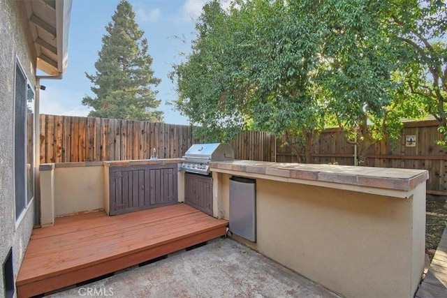 wooden deck featuring a grill