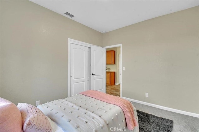 carpeted bedroom with a closet