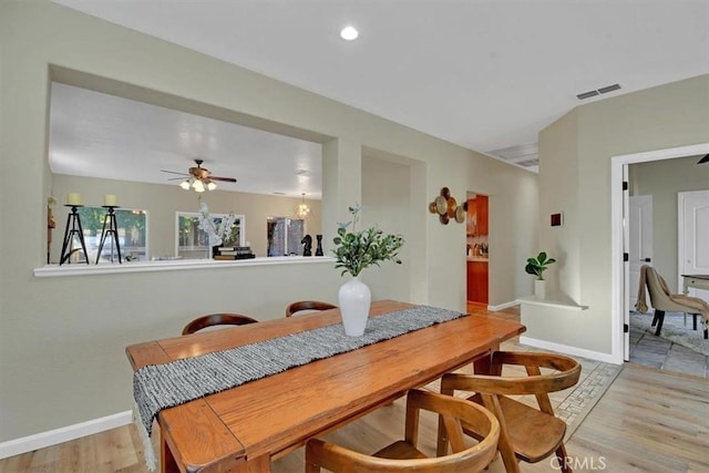 dining room with ceiling fan and light wood-type flooring