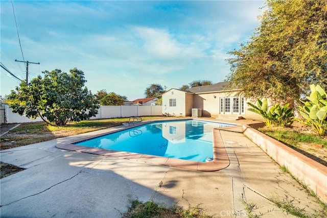 view of swimming pool with a patio and french doors