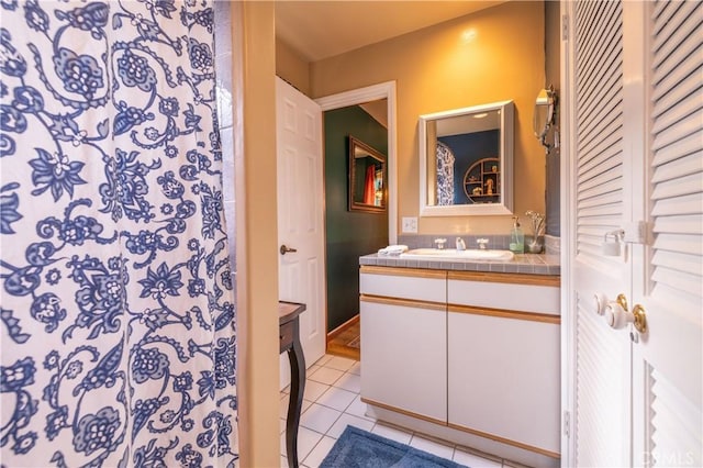 bathroom featuring curtained shower, tile patterned flooring, and vanity