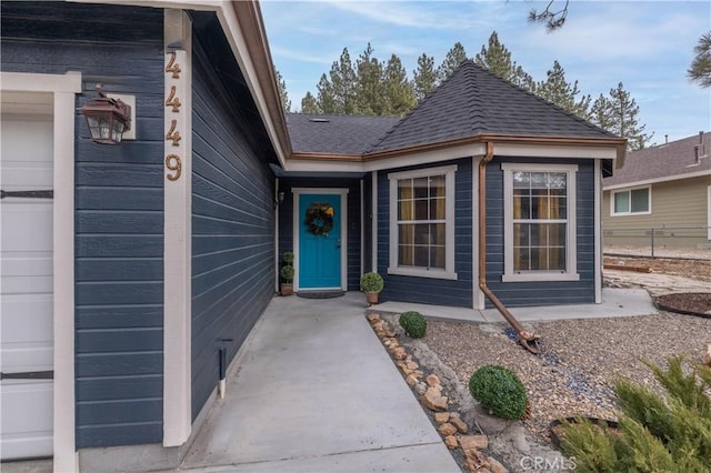 doorway to property with a garage