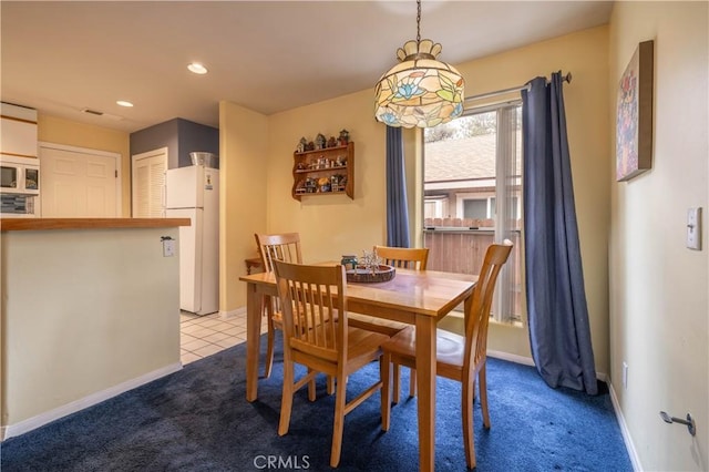 view of carpeted dining area