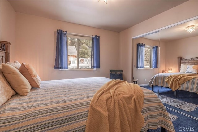 bedroom with carpet floors and a closet