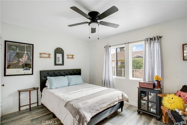 bedroom with wood-type flooring and ceiling fan